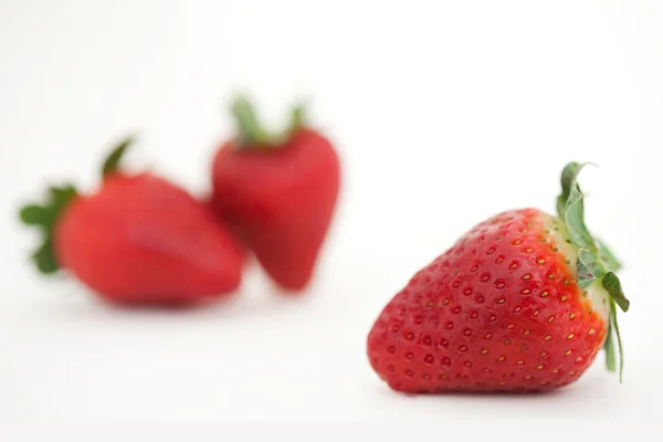 Red strawberries leaning together — ストック写真