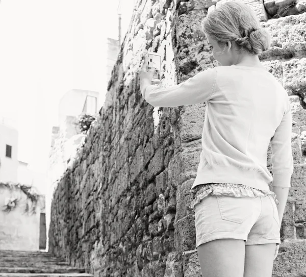 Woman using a smartphone device on the street — Stok fotoğraf