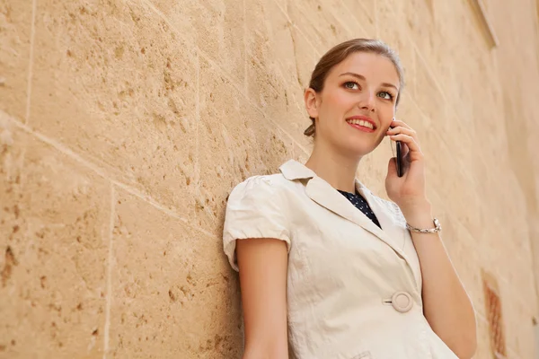 Business woman using a smartphone having phone call conversation — 图库照片