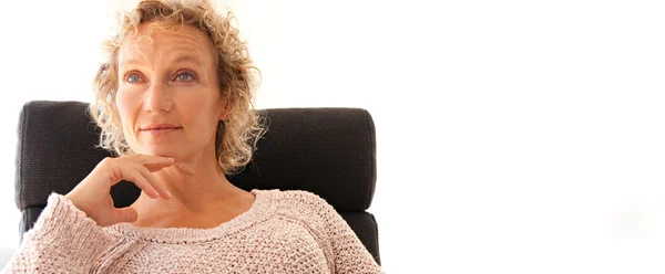 Mature woman sitting in an office chair — Stock Photo, Image