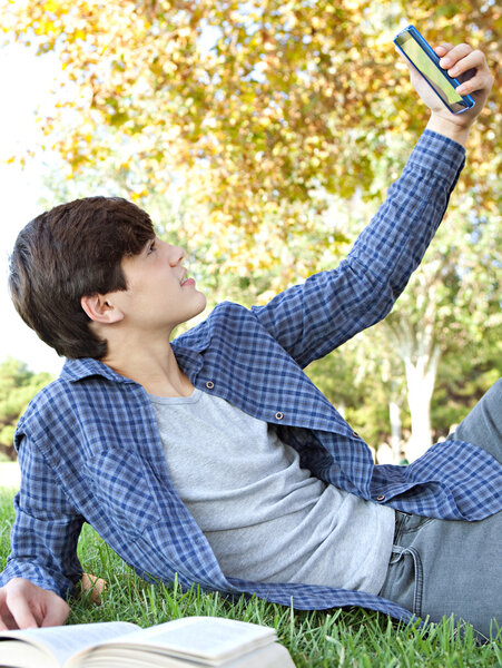 boy using a smartphone to take a selfy photo