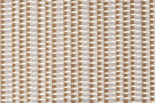 White and beige mat with interlinking stitches and vertical lines — Stock Photo, Image