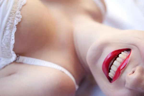 Sexy girl laying on a bed — Stock Photo, Image