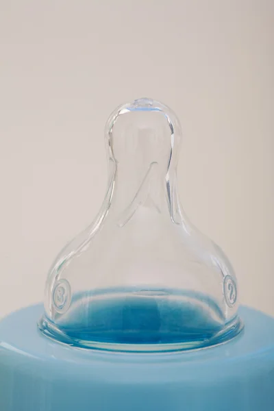 Blue glass baby bottle teat — Stockfoto