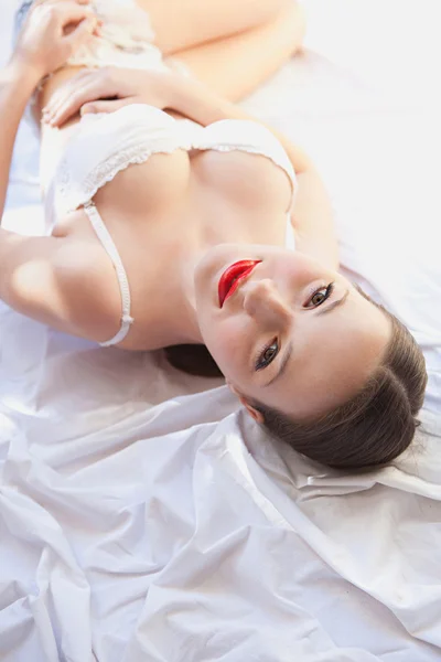 Sexy girl laying on a bed — Stok fotoğraf
