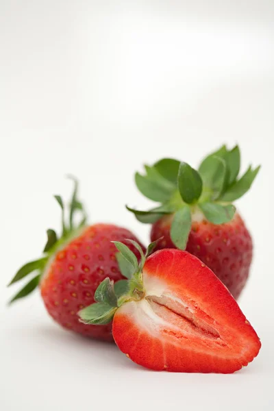 Red strawberries leaning together — ストック写真