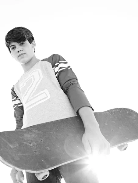 Teenager boy holding a skateboard — Stock Fotó