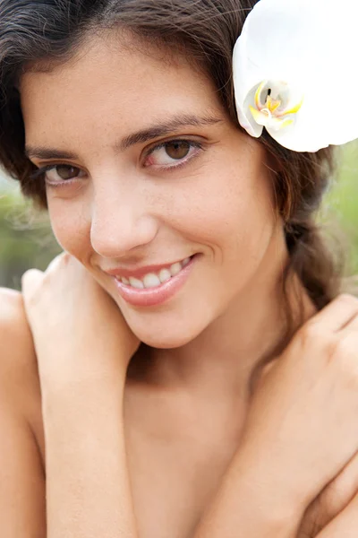 Woman elaxing in nature with flower in her hair — Stockfoto