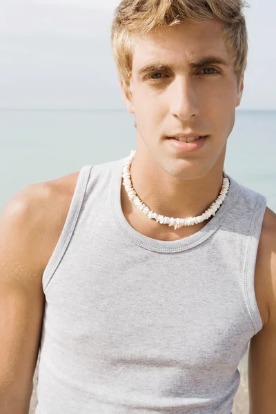 Portrait of an attractive teenager boy on a beach — ストック写真