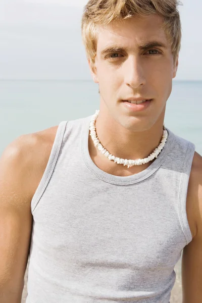 Portrait of an attractive teenager boy on a beach — Stockfoto