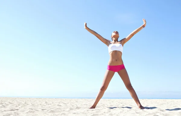 Young woman exercising on a bea — Stok fotoğraf