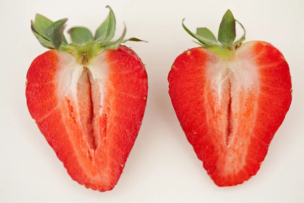 Red strawberry fruit cut in two halves — ストック写真