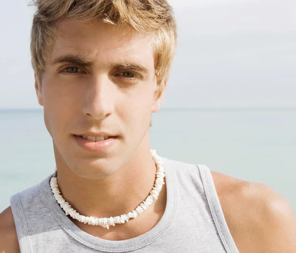 Portrait of an attractive teenager boy on a beach — Stock Photo, Image