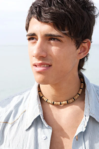 Portrait of an attractive teenager boy on a beach — Zdjęcie stockowe