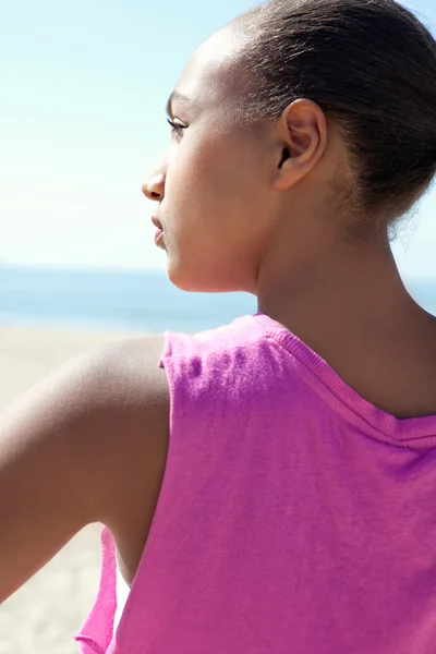 Jeune femme debout sur une plage de sable — Photo