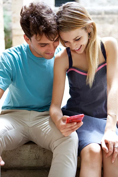 Couple using a smartphone to network Stockbild