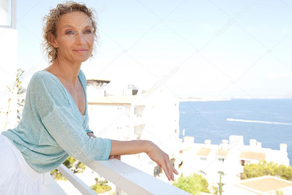 woman relaxing in resort hotel balcony