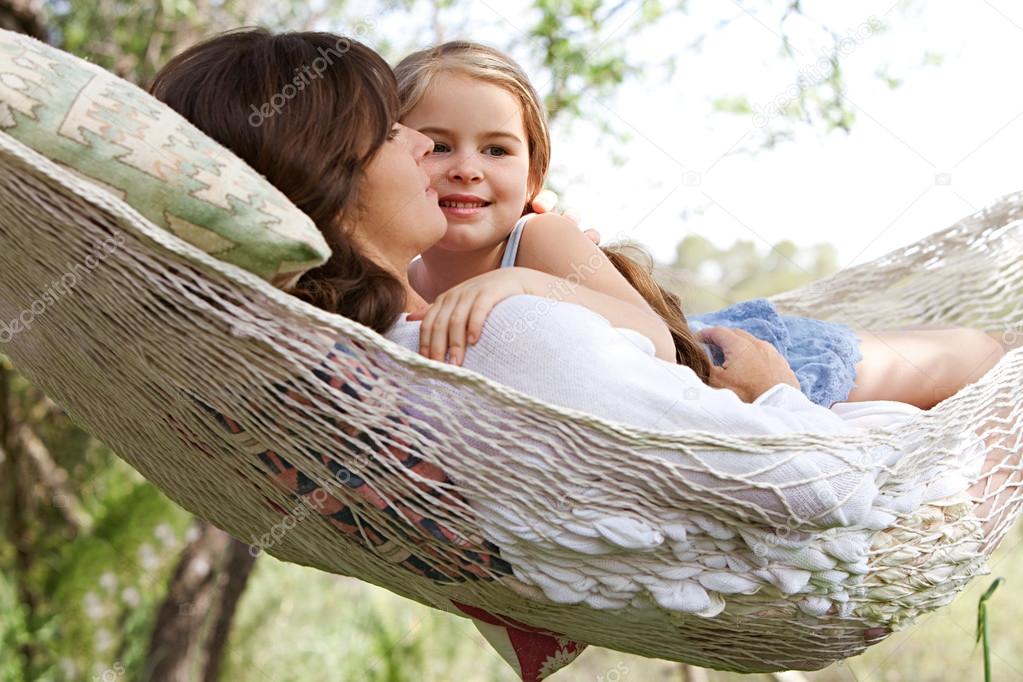 daughter and her mother laying together in a hammock