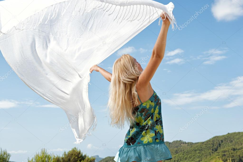 woman with white silk fabric in a forest