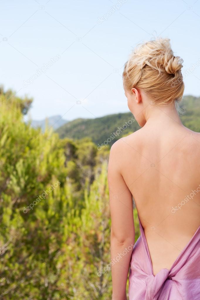 woman with a pink silk fabric in the mountains