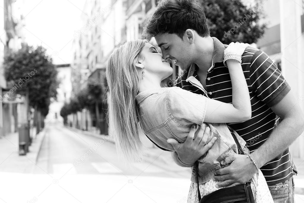 couple kissing and embracing while shopping