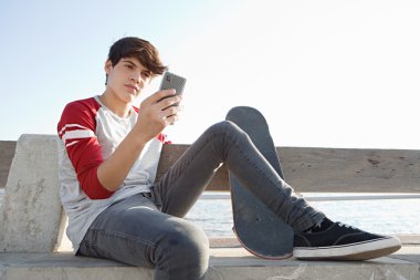 boy holding and using a smartphone
