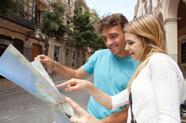 tourist couple reading a map
