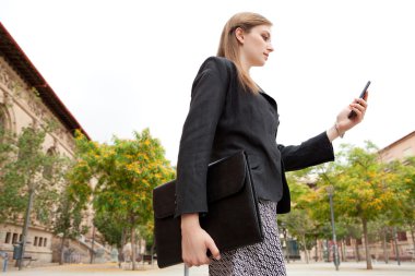 business woman holding and using a smartphone