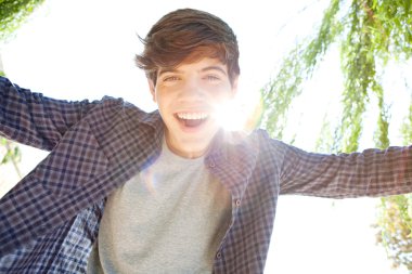 portrait of a teenager boy joyfully smiling