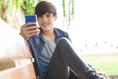 boy using his smartphone device to network