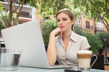 business woman at a cafe using a laptop computer