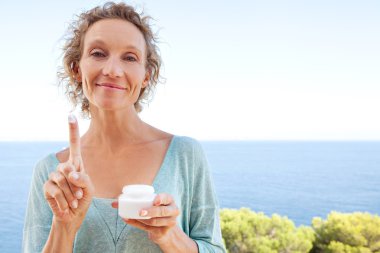 woman with cream on a resort hotel balcony