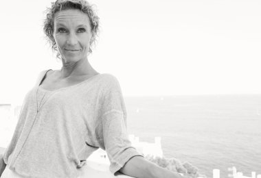 woman relaxing in resort hotel balcony