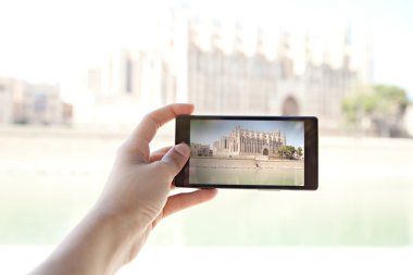 woman taking photos of a monument cathedral