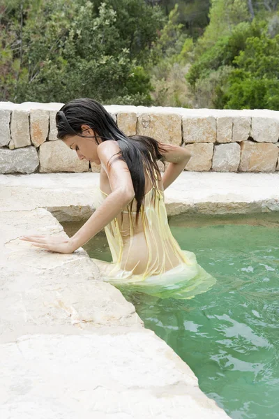 Woman in a natural swimming pool — 图库照片