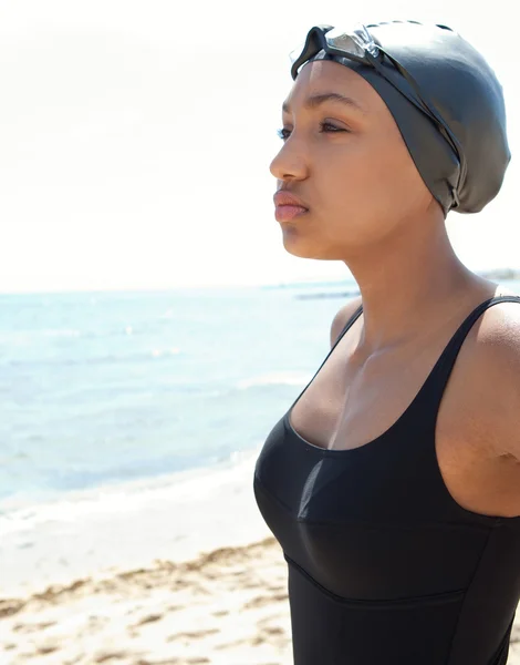 young woman swimmer on a beach