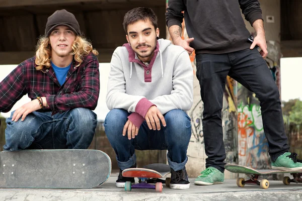 Друзья подростки занимаются спортом в скейтбординговом парке — стоковое фото
