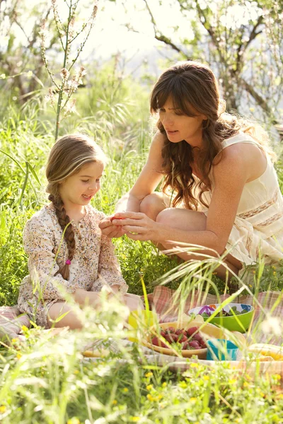 Madre e figlia che fanno un picnic in un giardino — Foto Stock