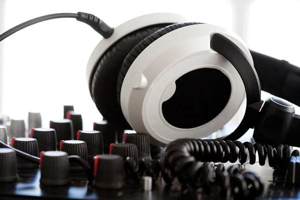 Headphones laying on a DJ mixer — ストック写真