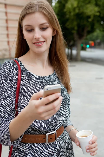 Business woman using a smartphone on her way to work — 图库照片