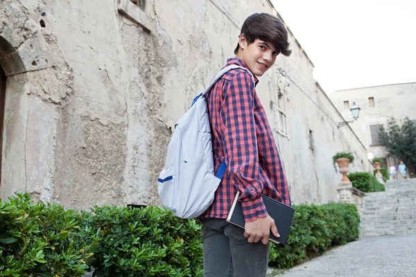 Student boy walking up the stairs — Stock fotografie