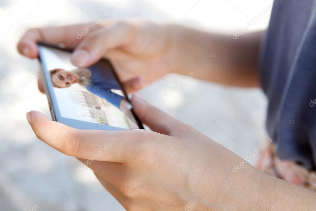 woman hand holding and using a touch screen smartphone
