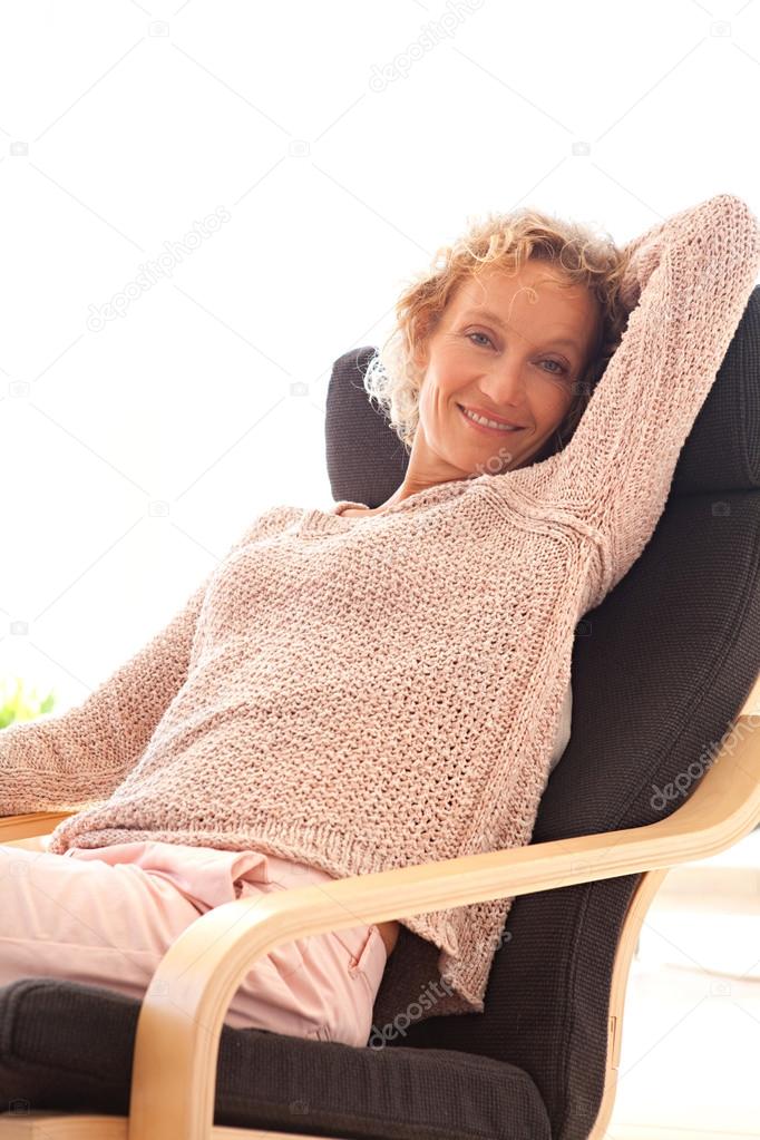 woman sitting and relaxing on a comfortable armchair