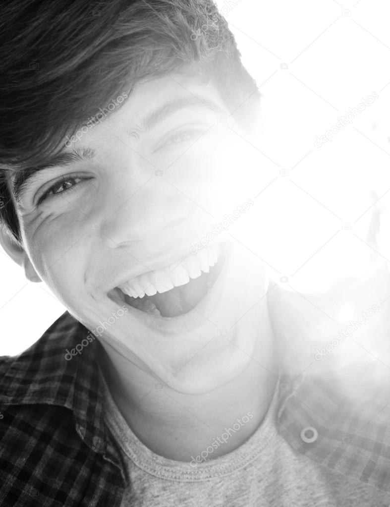 portrait of a teenager boy joyfully laughing