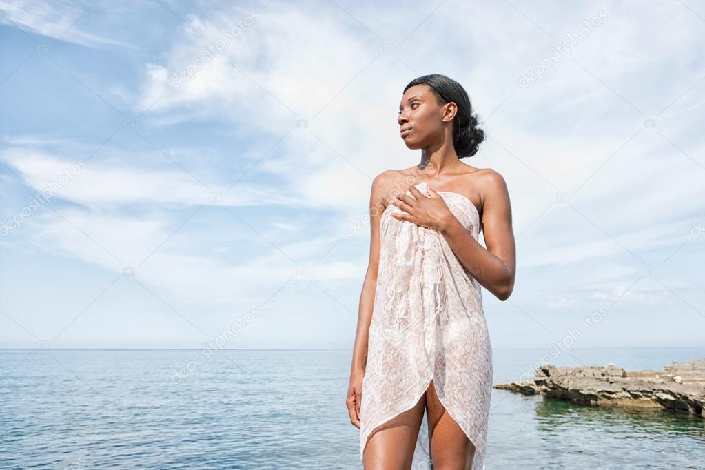attractive black woman relaxing near the sea