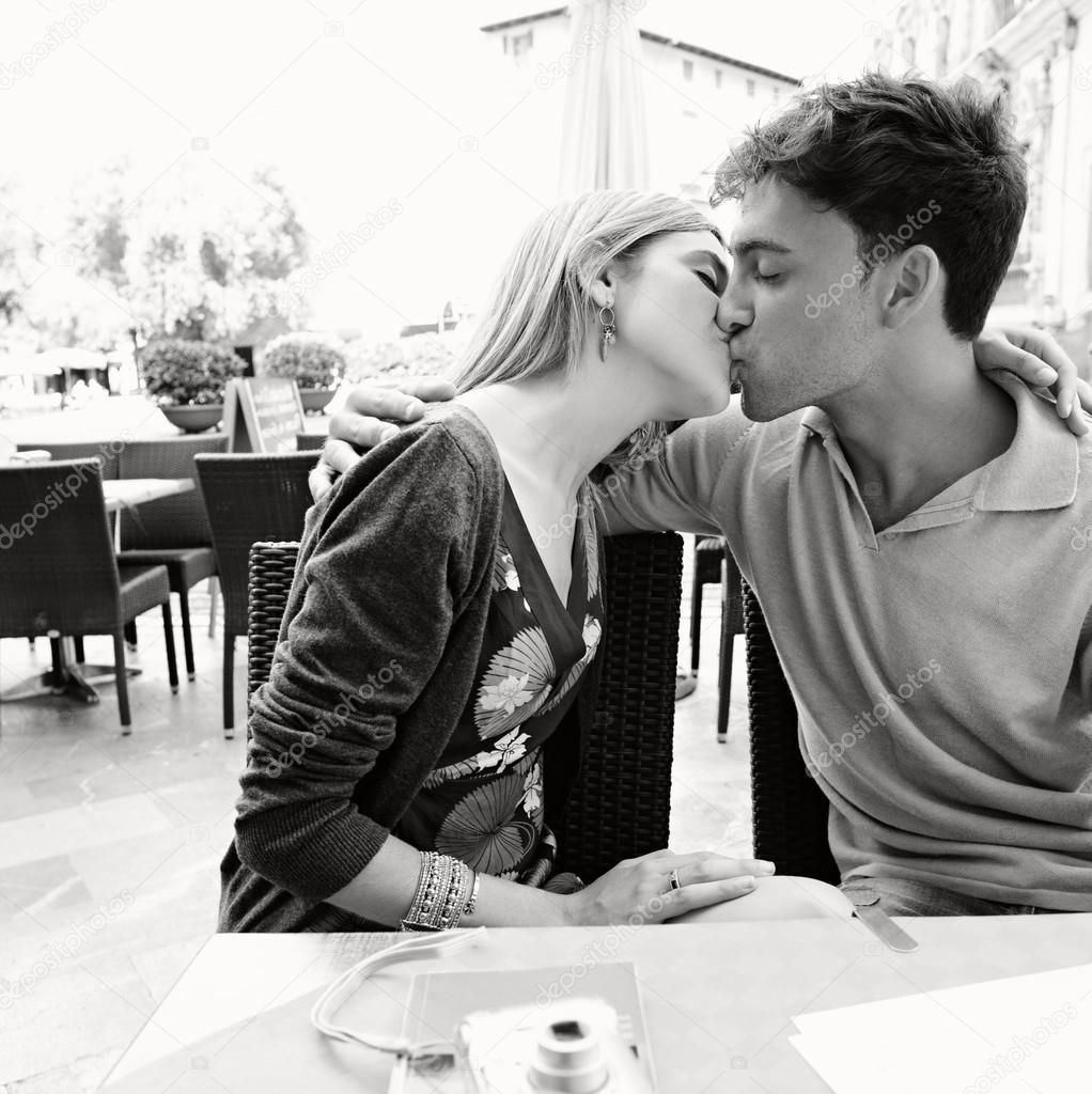 couple kissing at cafe