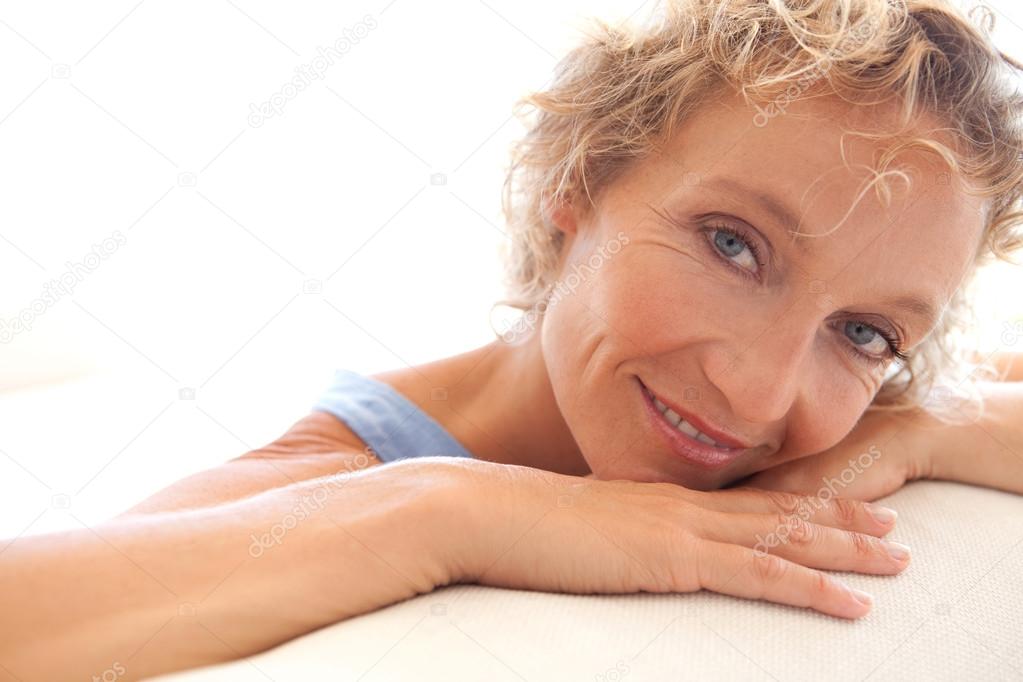 woman relaxing on a white sofa at home