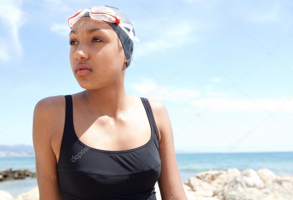 young woman swimmer on a beach