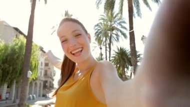 woman taking selfies videos of herself on camera