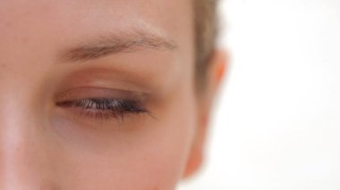 woman eye looking at the camera and blinking slowly